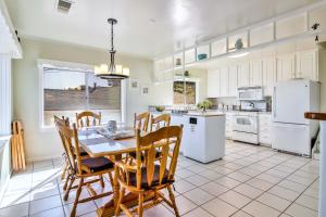 a kitchen with a table and chairs and white appliances at Stunning Monterey Home with Views Right on the Bay! in Monterey