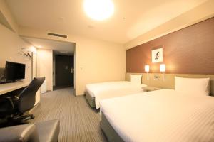 Postel nebo postele na pokoji v ubytování Daiwa Roynet Hotel Tokyo Osaki