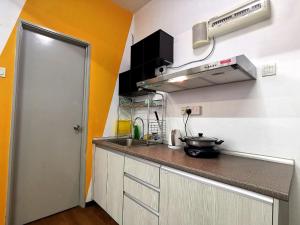 a small kitchen with a counter and a sink at A's House i-City 1-4pax Studio Netflix Wifi in Shah Alam