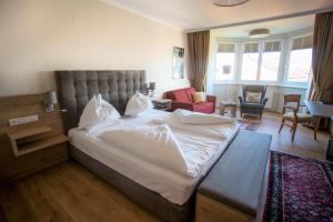 Der Marienhof Hotel Garni في غراتس: غرفة نوم بسرير كبير وغرفة معيشة