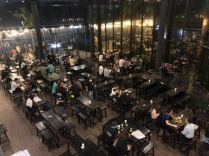 a group of people sitting at tables in a restaurant at 28 Boulevard Superior 2 Bedroom Resort Facilities 3-6km to Velocity TRX KLCC in Kuala Lumpur