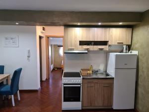 a kitchen with a sink and a stove top oven at Apolon in Novi Sad