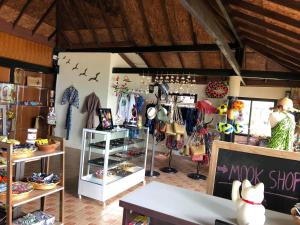 a clothing store with a woman standing in a room at Koh Mook Sivalai Beach Resort in Ko Mook