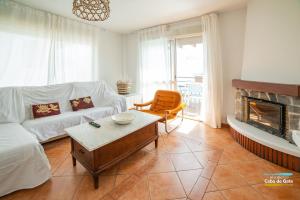 a living room with a couch and a fireplace at CASA LILLEMOR in San José