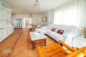 a living room with a white couch and a table at CASA LILLEMOR in San José