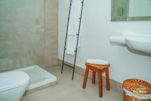 a bathroom with a toilet and a sink and a stool at CASA LILLEMOR in San José +26 photos