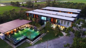 an aerial view of a house with a swimming pool at Sappaya Hotel By Lotus Valley Golf Resort in Chachoengsao