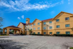 a large building with a parking lot in front of it at La Quinta by Wyndham Pasadena in Pasadena