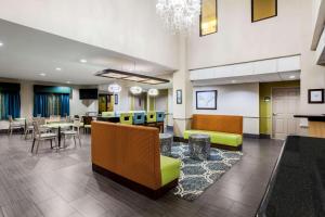 a lobby of a hospital with tables and chairs at La Quinta by Wyndham Pasadena in Pasadena