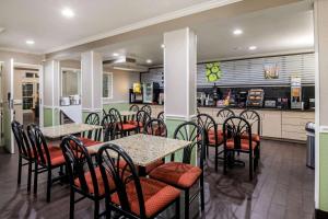 a dining room with tables and chairs in a restaurant at La Quinta Inn by Wyndham San Antonio Brooks City Base in San Antonio
