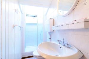 a bathroom with a sink and a toilet and a mirror at Appartamento MARMOLADA - CANAZEI in Canazei +26 photos