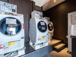 a row of washing machines in a store at APA Hotel Kyoto Eki Horikawadori in Kyoto