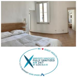 a white bedroom with a bed and a mirror at Santa Maria Suites in Rome