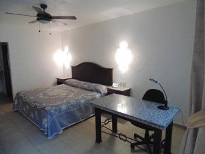 Postel nebo postele na pokoji v ubytování Hotel Hacienda
