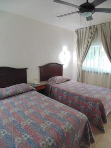 Postel nebo postele na pokoji v ubytování Hotel Hacienda