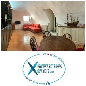 a kitchen and a living room with a table at Le Tartarughe Boutique Apartment in Rome