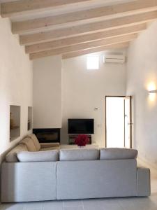 a living room with a couch and a tv at Can Vicent Yern in Sant Francesc Xavier