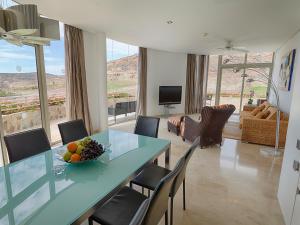a living room with a table with a bowl of fruit at Anfi del Mar Tauro Golf 2 Emerald Club in Mogán