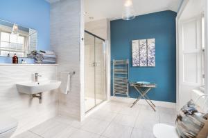 a bathroom with a sink and a shower at Haymarket Apartments in Edinburgh +49 photos