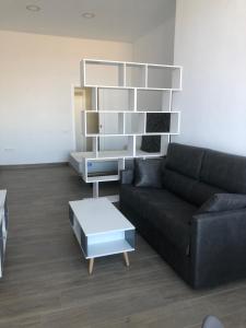 a living room with a couch and a coffee table at Apartamentos turísticos Conil luz in Conil de la Frontera