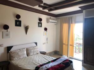 a bedroom with a bed and a large window at reda land in Ben Slimane +50 photos
