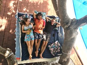 people are sitting on a bench under an umbrella at Darwin Hostel in Darwin