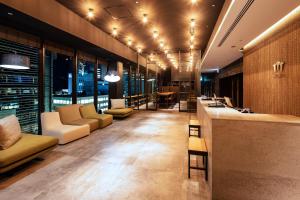 a lobby with couches and a bar in a building at Sanco Inn Grande Nagoya -HOTEL & SPA- in Nagoya