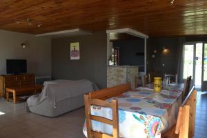 a living room with a table and a couch at Village de gîtes Les Olivettes in Saint-Dézéry