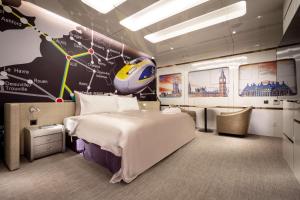 a bedroom with a large bed and a map at AURORA MOTEL in Taichung