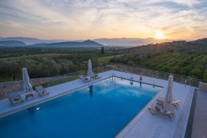 a swimming pool with a view of the mountains at Anassia Villas in Nafplio