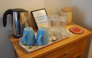 a wooden counter with cups and other items on it at No9 Guesthouse in Hunstanton