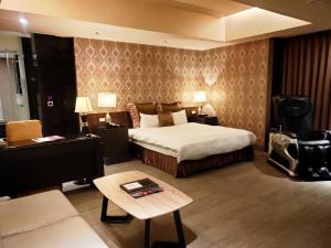 מיטה או מיטות בחדר ב-Discovery Motel - Nangang