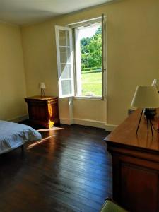 an empty room with a bed and a window at La Dilettante in Malause