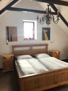 a bedroom with a large wooden bed in a room at Pension Töpferhof in Bad Berka