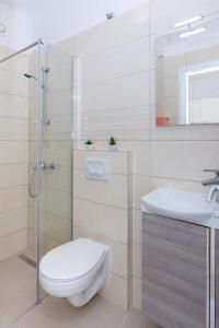 a bathroom with a toilet and a sink at Apartments Luka in Pag +52 photos