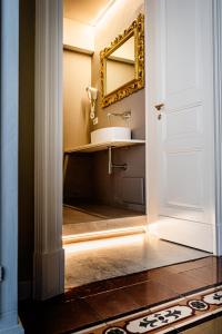 a bathroom with a sink and a mirror at B&B Palazzo Cerami in Catania
