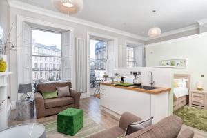 a kitchen and living room with a sink and a living room at Haymarket Apartments in Edinburgh