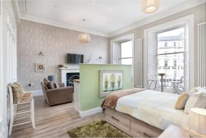 a bedroom with a bed and a living room at Haymarket Apartments in Edinburgh