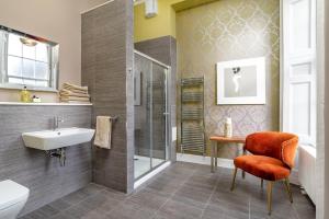 a bathroom with a tub, toilet, sink and shower at Haymarket Apartments in Edinburgh