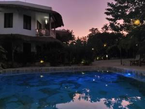 a swimming pool in front of a house at night at Aldea Balam in Tulum