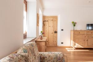 Cama ou camas em um quarto em La Gerla Casa Vacanze Dolomiti