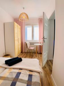 a bedroom with a bed and a table at Apartament Niedźwiadek in Ustrzyki Dolne