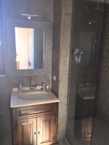 a bathroom with a sink and a mirror and a shower at SUPERATTICO SUL COLOSSEO in Rome