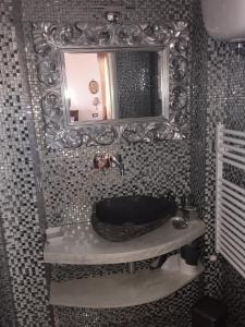 a bathroom with a large mirror and a bath tub at SUPERATTICO SUL COLOSSEO in Rome