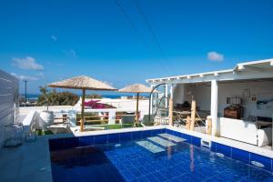 a swimming pool with a view of the ocean at Hidden Heaven in Mikonos