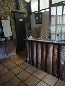 a kitchen with a wooden bar in a room at Posada de Ziga in Ziga