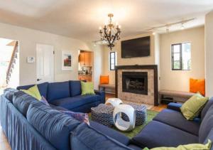 a living room with a blue couch and a fireplace at Lg BEACH Home, POOL, Hot Tub, Close to Beaches & Downtown El Segundo Beach in El Segundo