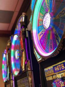 a row of colorful pinball machines in a casino at Mineral Palace Hotel & Gaming in Deadwood