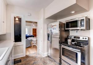 a kitchen with a stainless steel refrigerator and microwave at 30 Day+ Craftsman; Stroll 2 Food & Downtown! in Portland