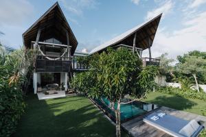 an exterior view of a house with a swimming pool at LeBAOH VILLA - Lembongan island in Nusa Lembongan